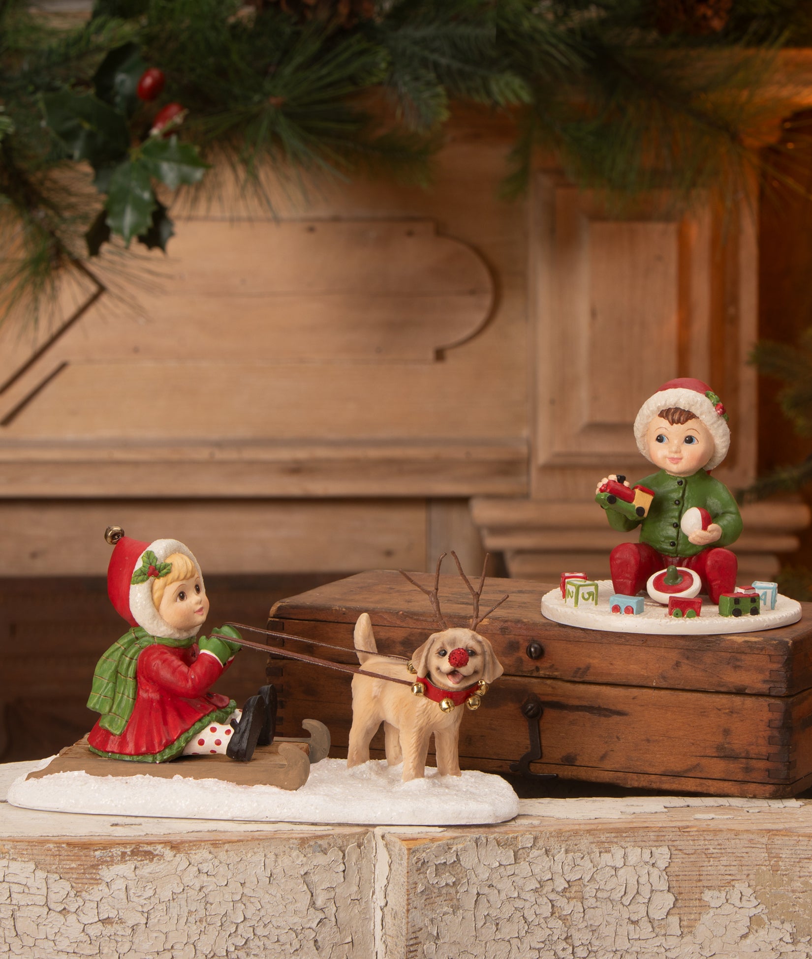 Bethany Lowe Christmas Figurines, Clare Sledding with Dog and Baby Carson with Toys.