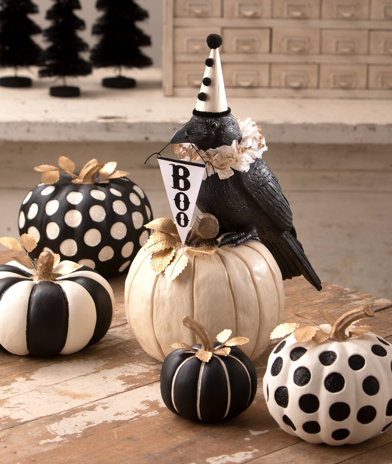 Black and white pumpkins with a crow holding a Boo Sign from the Bethany Lowe Halloween 2026 Collection.