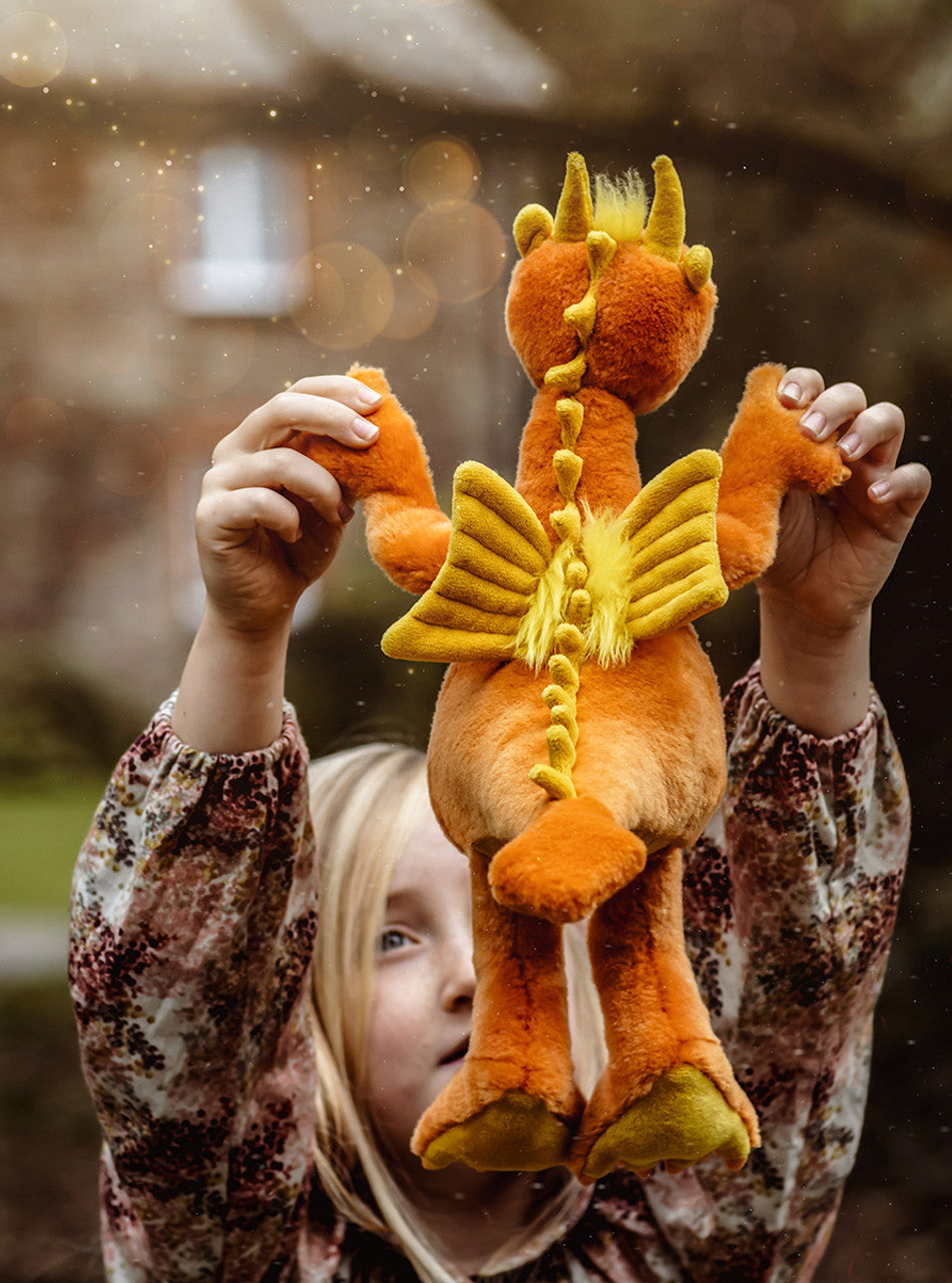 Child Playing with Dragon Stuffed Animal with Orange and Yellow Plush by Charlie Bears