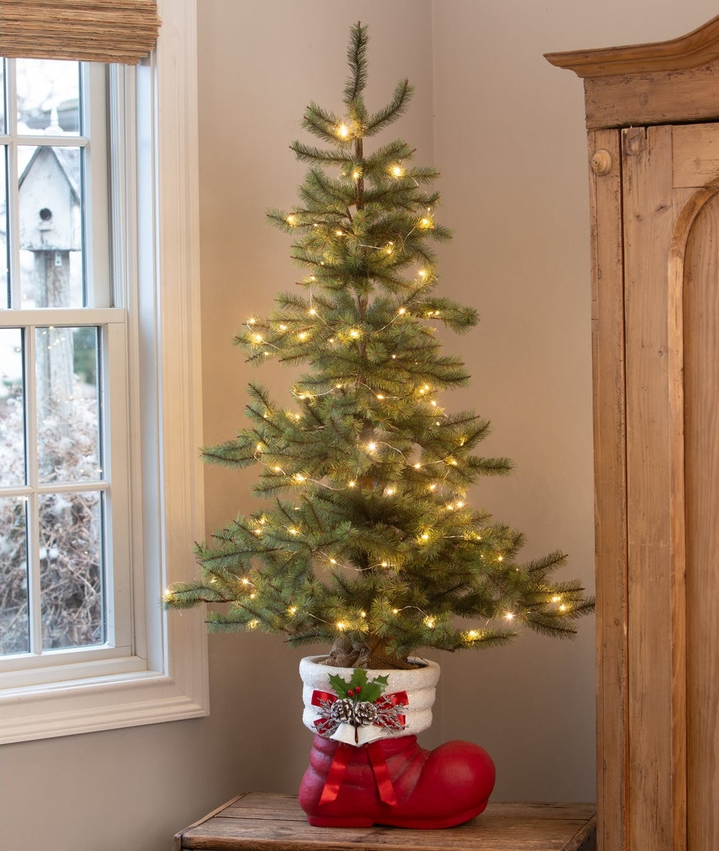 Retro Red Santa Boot shown being used as a Christmas Tree Base