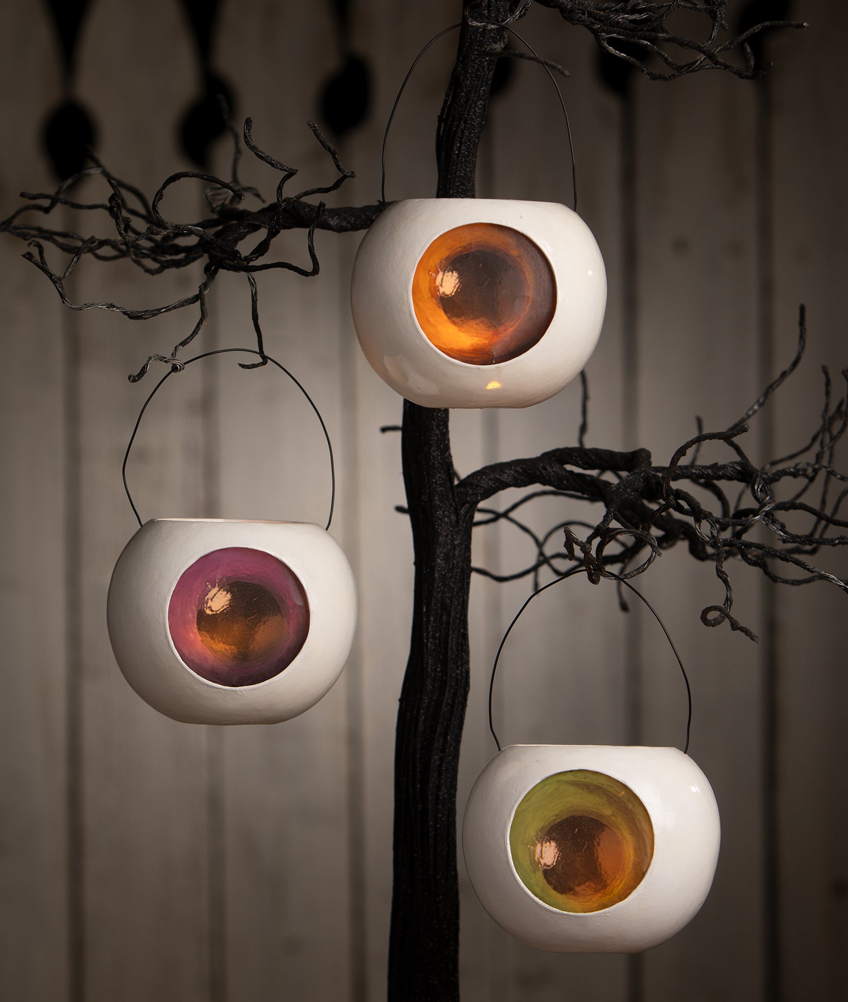 Glowing Eyeball Buckets used as Halloween Ornaments in a spooky tree