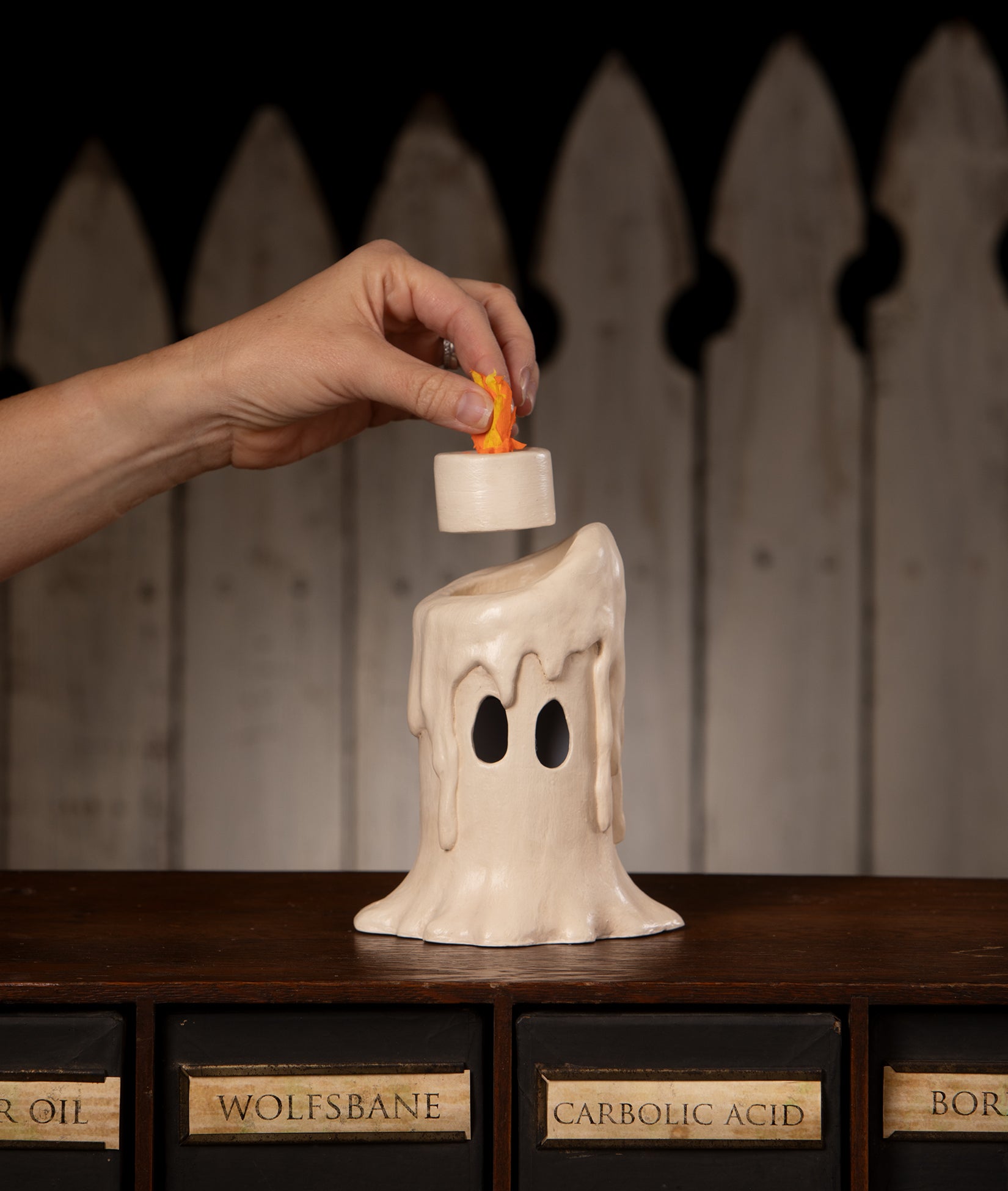 Ghost Candle Luminary from the 2026 Bethany Lowe Halloween Collection shown with faux flame being removed.