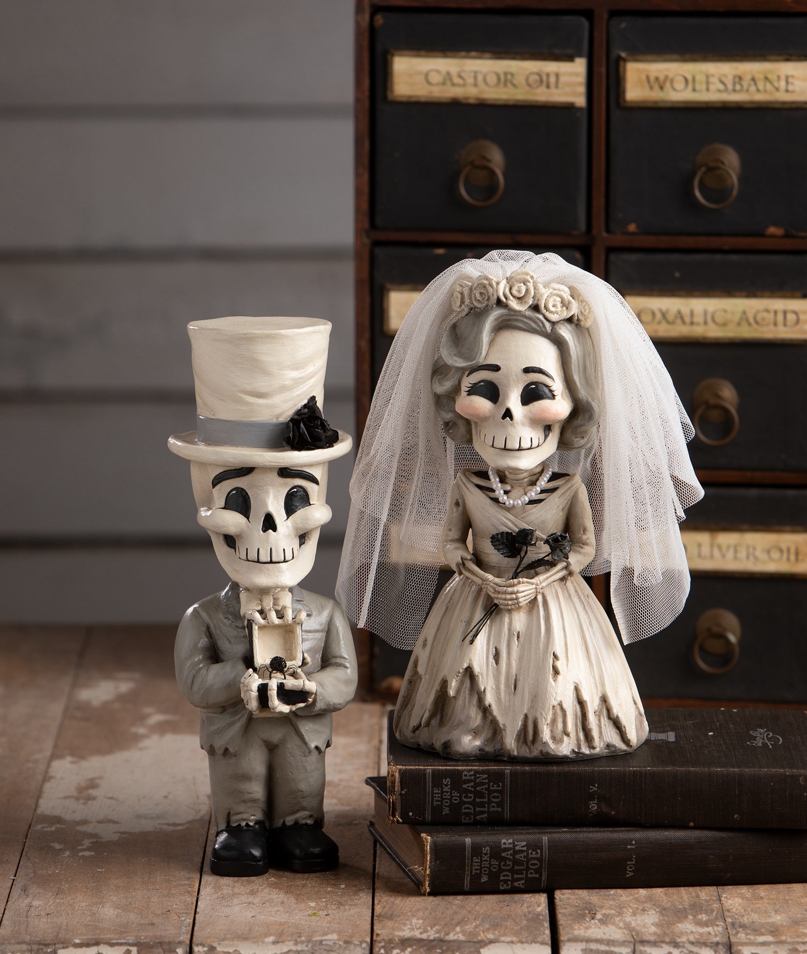 Skeleton bride and groom figurines in front of vintage drawers. Halloween wedding decorations. Bethany Lowe 2026.