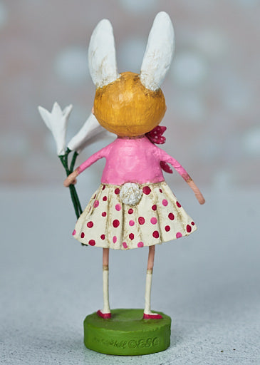ri Mitchell Easter Lily Figurine wearing bunny ears and holding a bouquet of flowers