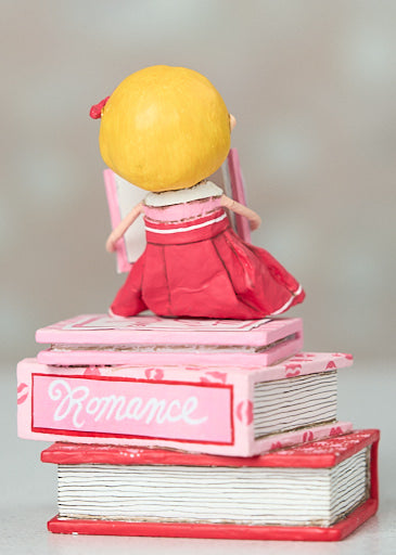 Lori Mitchell Love Story Figurine Reading and Sitting on Romance Novels