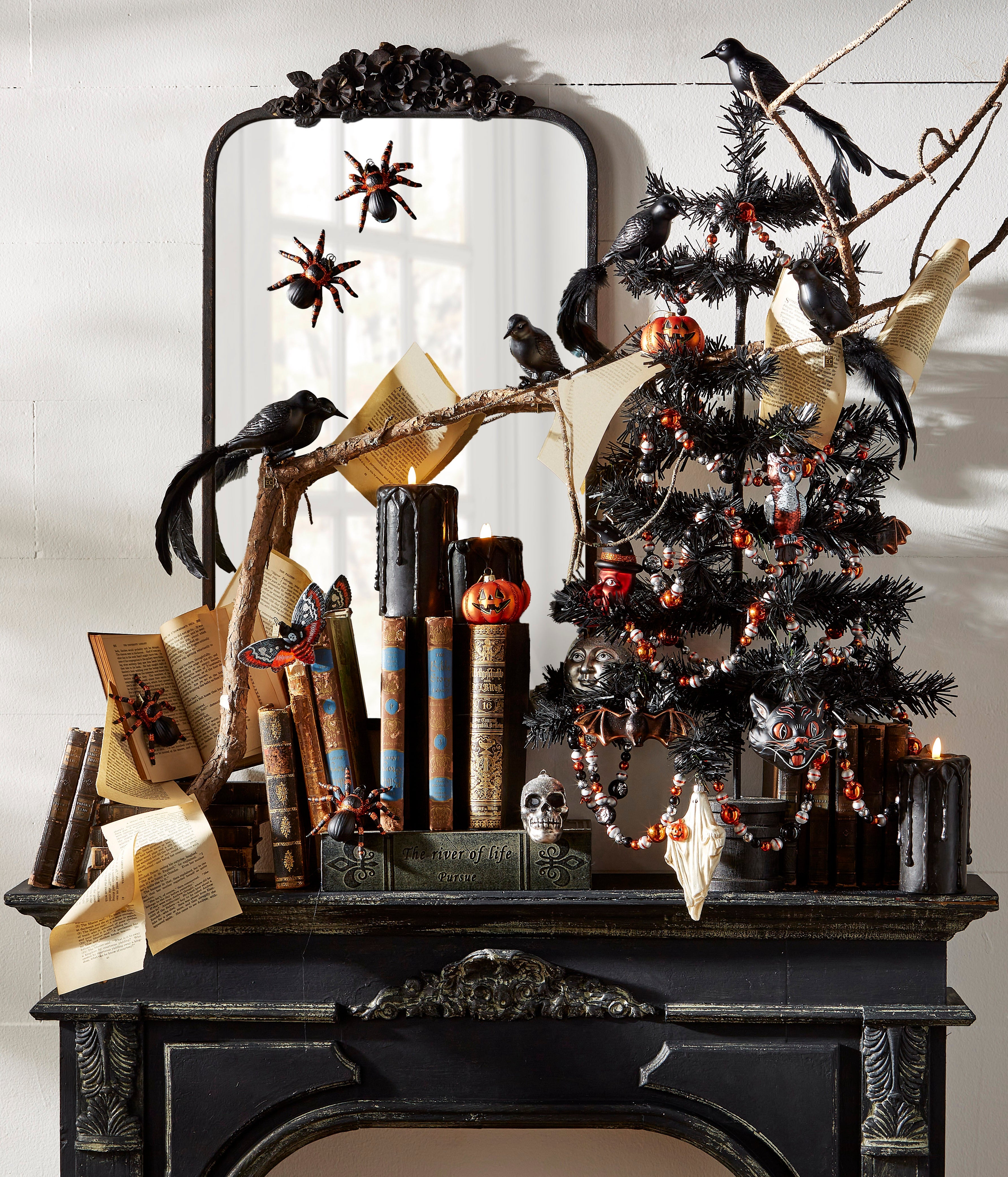 Mantle Dec orated for Halloweenn with glass Halloween ornaments on a black tree