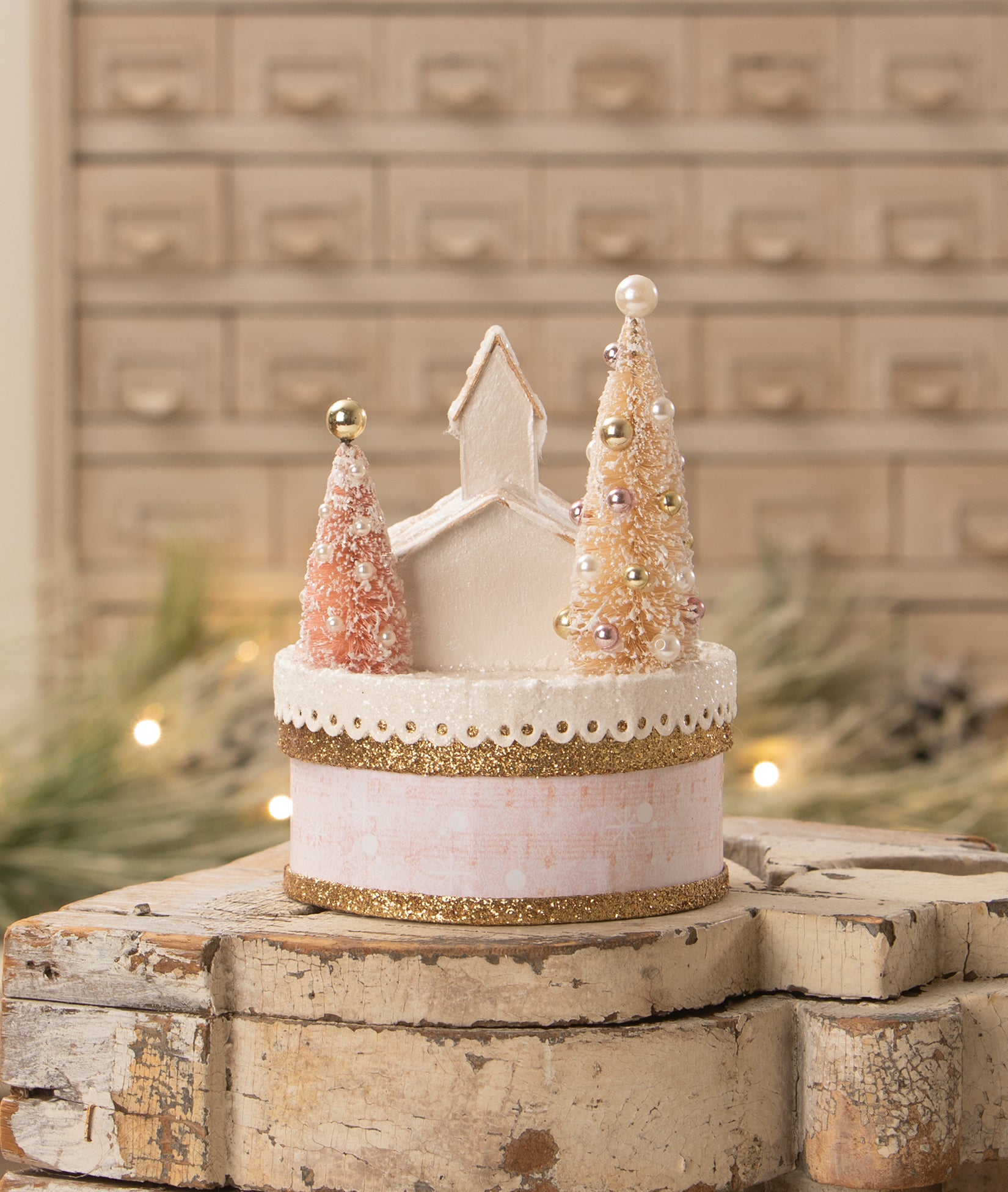 Pink Church Christmas Scene on Round Box with Banner that reads, Peace on Earth."