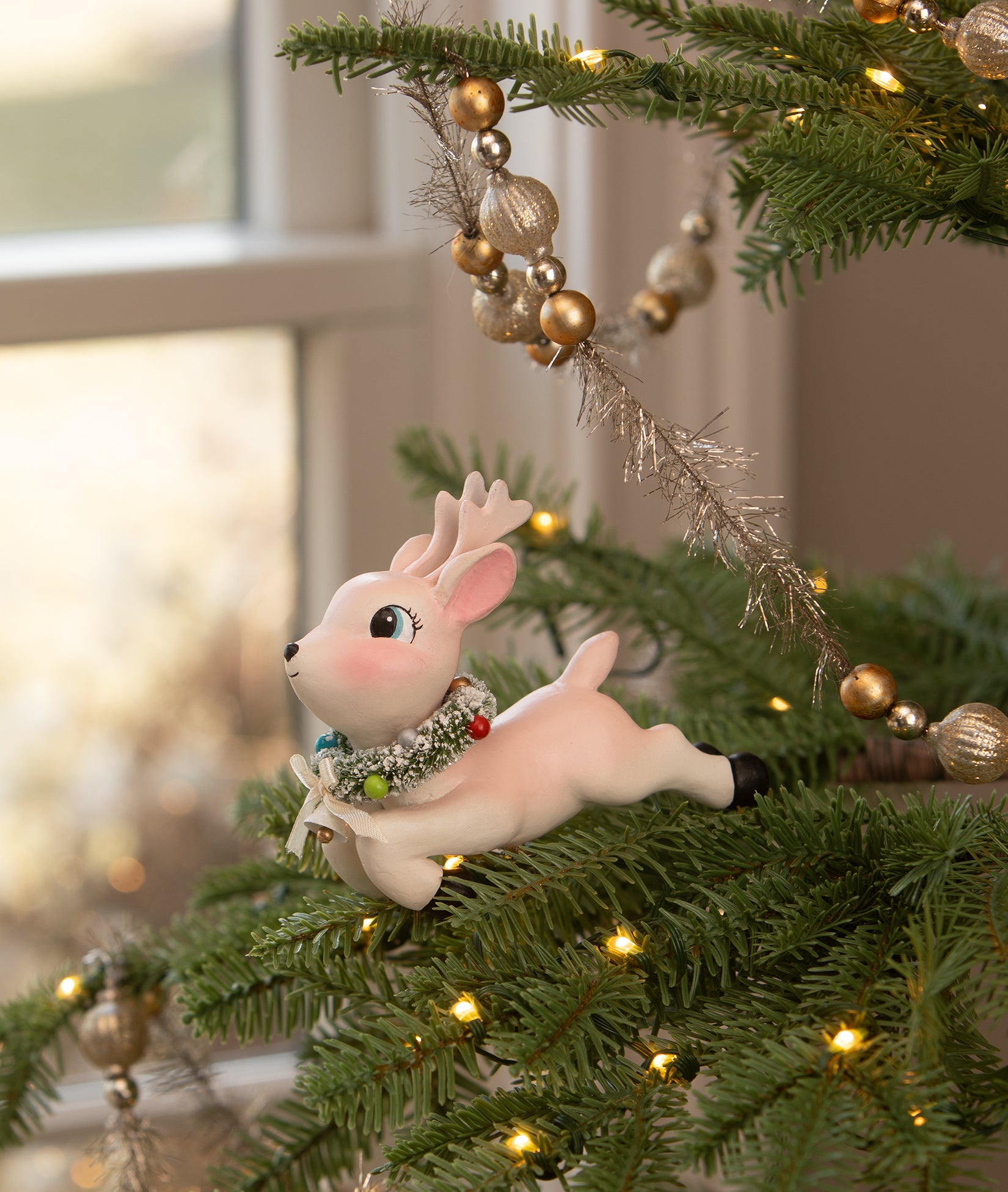 Retro Pink Reindeer Leaping High Ornament Clip in a Christmas Tree
