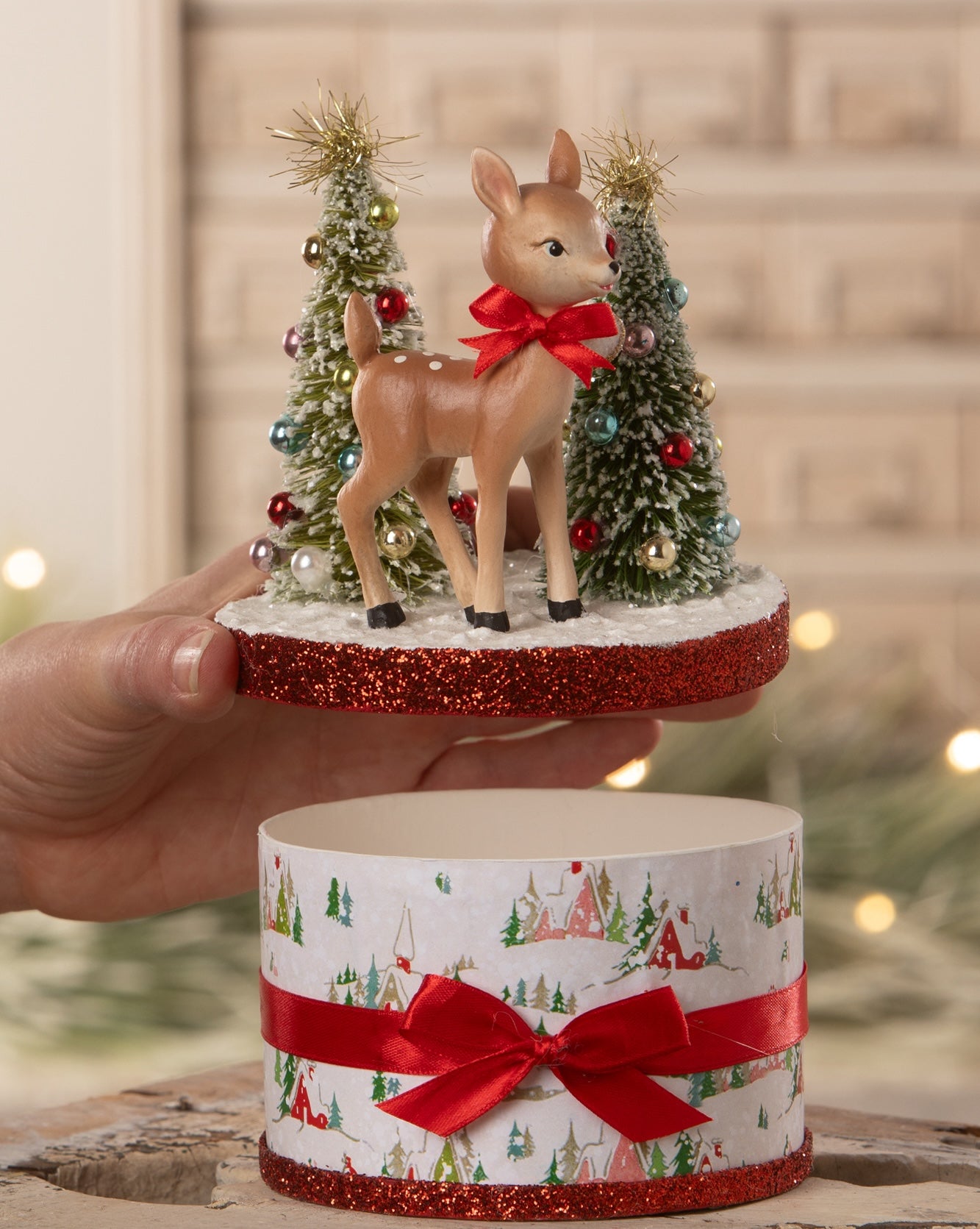 Retro Reindeer Box with Christmas scene on top, being opened.