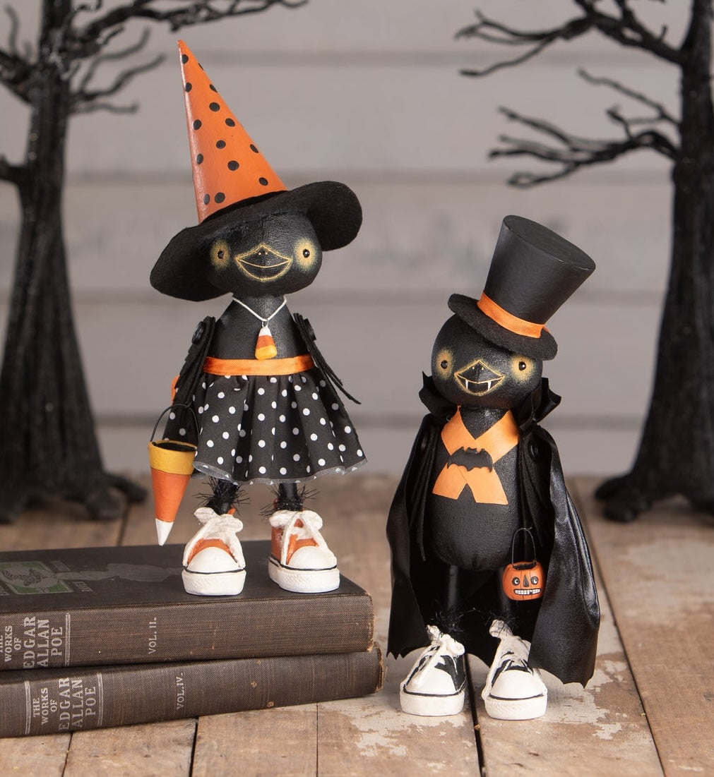 Clara Crowloff & Boris Crowloff are crow figurines that are dressed up for Halloween in Witch and vampire costumes. These Halloween decorations are unique, cute and not-so-scary.
