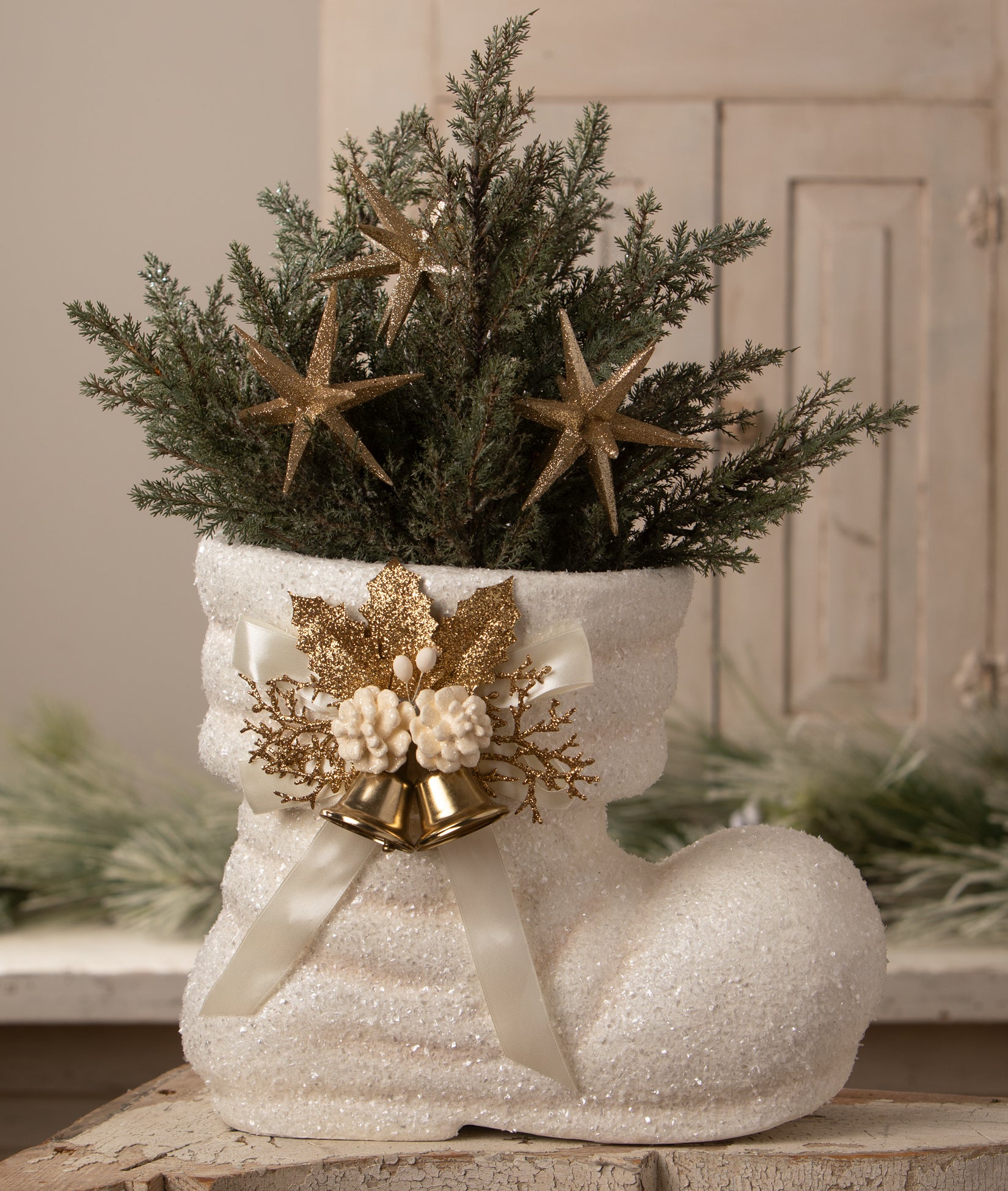 Winter White Santa Boot decorated with faux greens and gold Christmas decorations