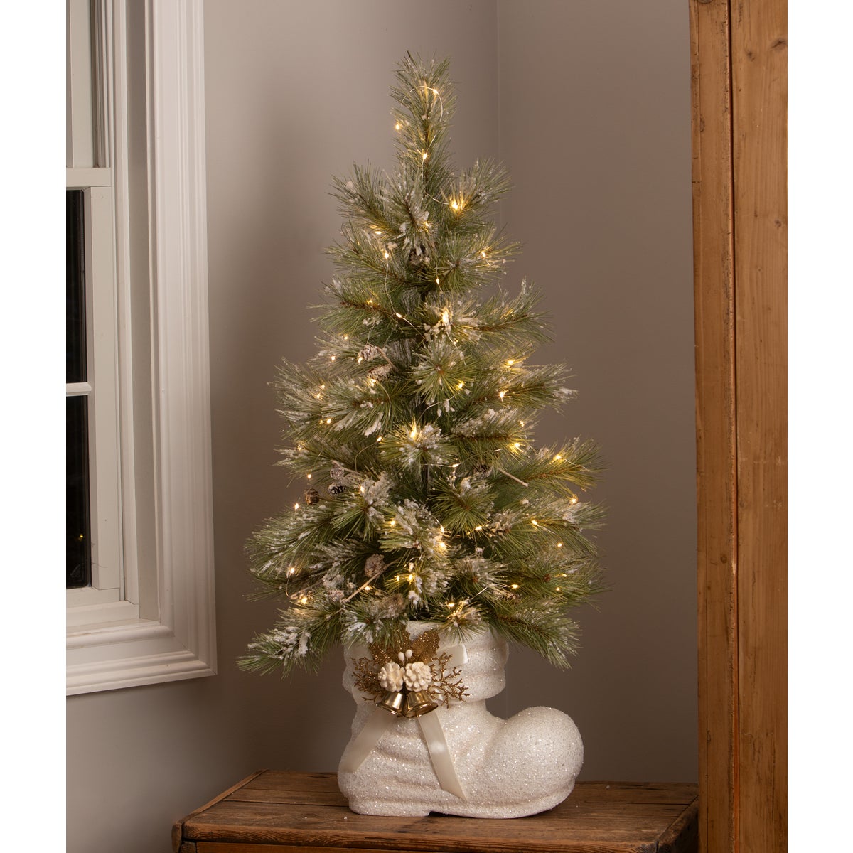 Christmas tree in a White Santa Boot base.