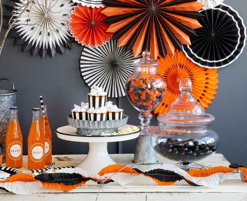 Retro Halloween Party Setting with Rossettes, Party Cups, and Candy