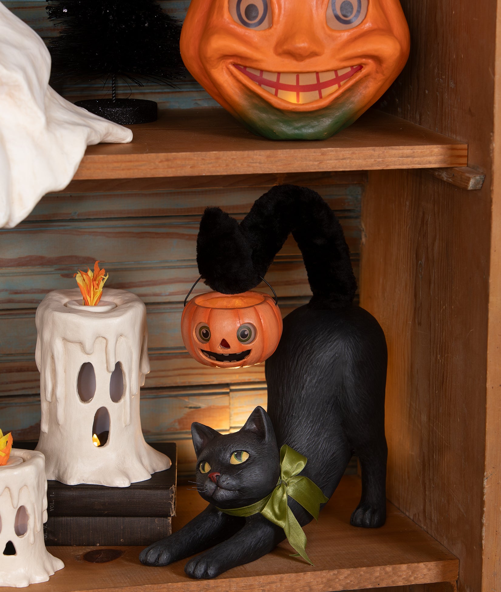 Pumpkin Prowler Cat shown on a shelf with Vintage-Inspired Halloween Decorations.