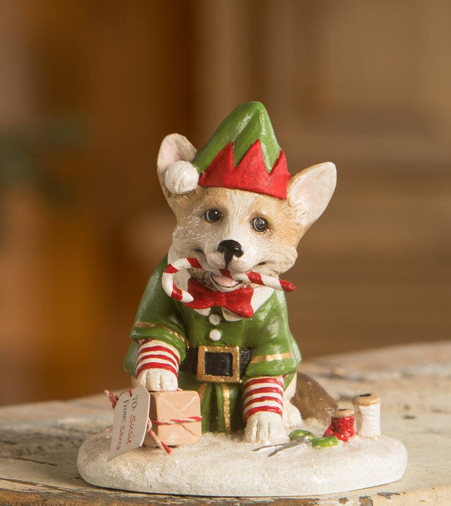 Wrapping it Up Corgie Figurine dressed as an elf wrapping gifts