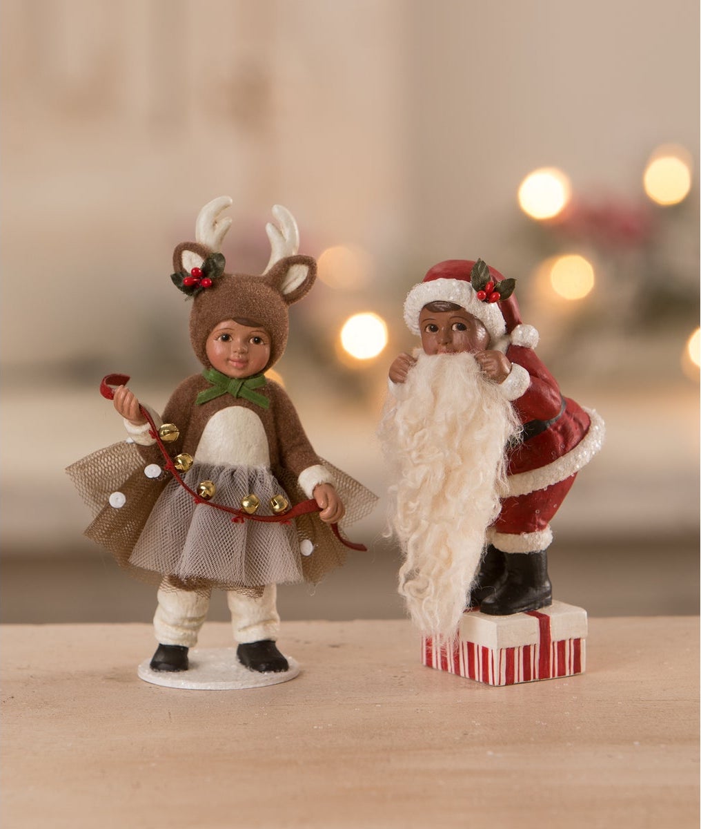 Little Girl Dressed in Reindeer Costume Figurine pictured with boy in Santa suit figurine