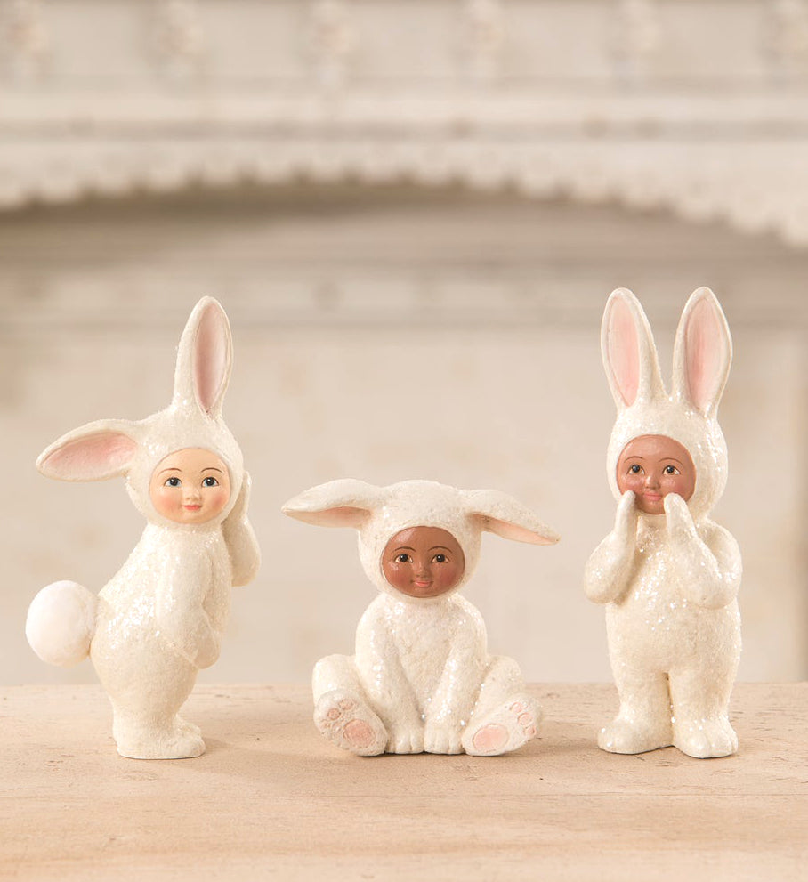 Kids dressed up as bunny rabbits, Easter figurines
